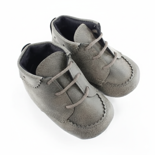 Pair of gray baby shoes with laces on a white background